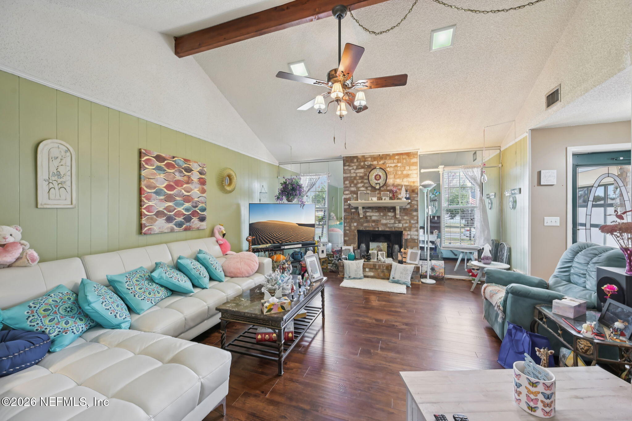 2749 Richards Road Orange Park, FL 32073 - Photo 3 of 26 a living room with furniture a fireplace and a chandelier