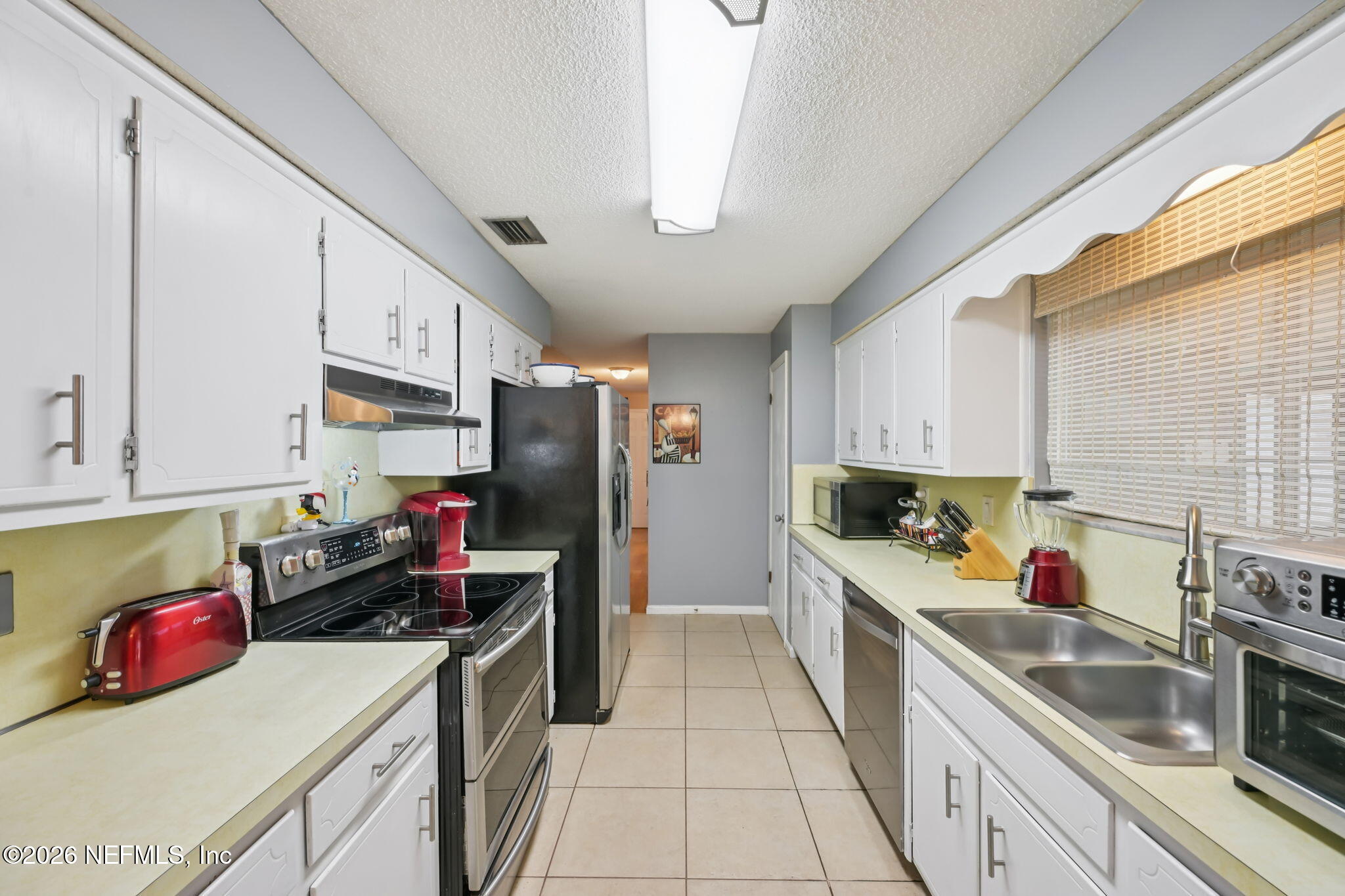 2749 Richards Road Orange Park, FL 32073 - Photo 7 of 26 a kitchen with stainless steel appliances a stove refrigerator sink and cabinets