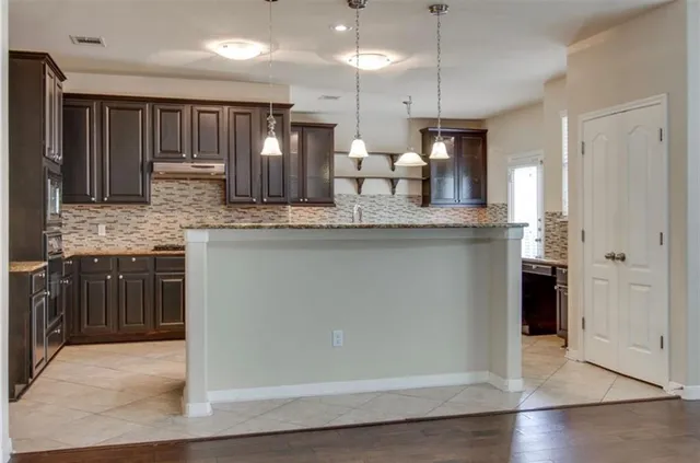 a kitchen with counter top space cabinets and stainless steel appliances