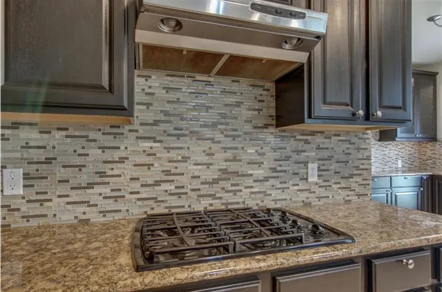 a close view of a stove a microwave and cabinets in the kitchen