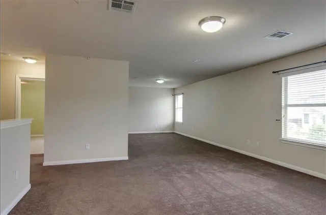 an empty room with a empty space and windows