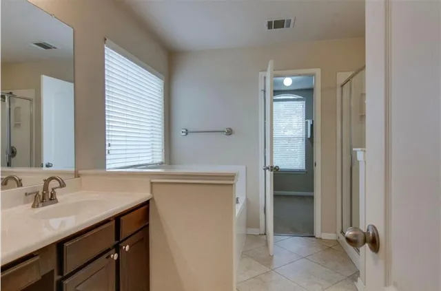 a bathroom with a sink a light fixture and a mirror