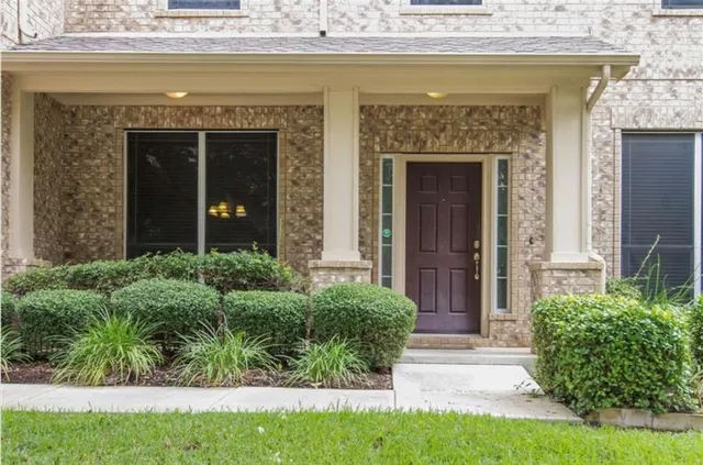 a view of front door and small yard