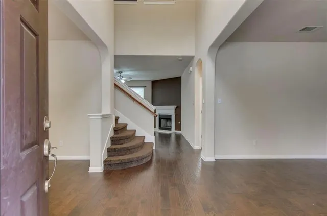 a view of entryway and hall with wooden floor