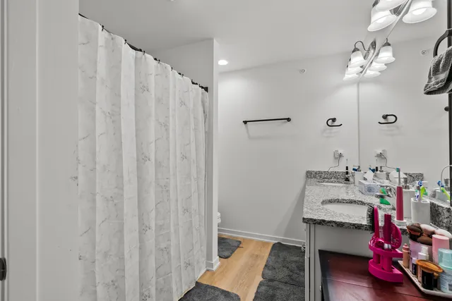 a bathroom with a sink vanity and a mirror