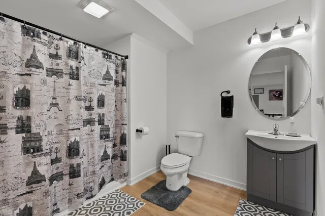 a bathroom with a sink toilet and shower