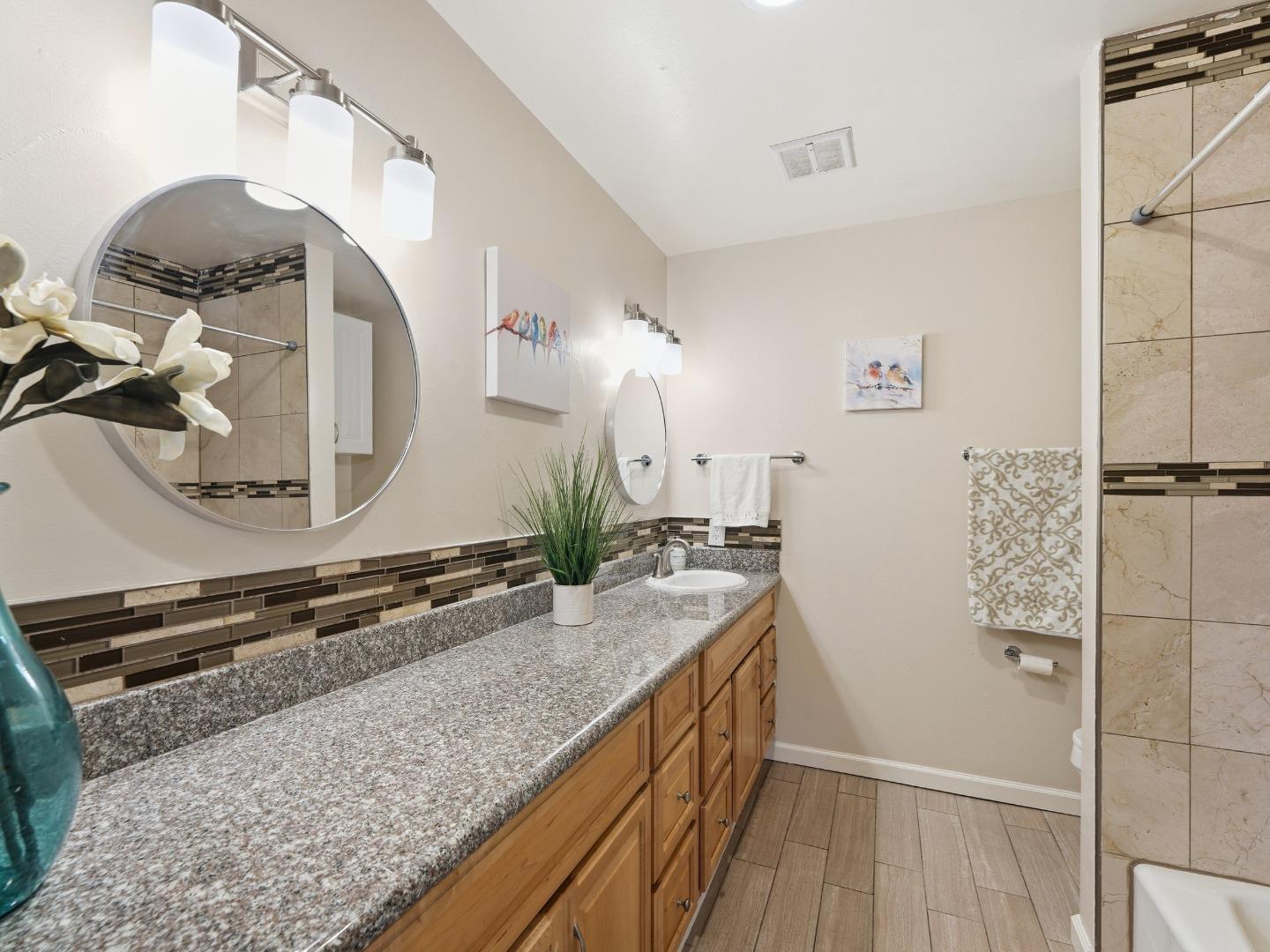 607 Valley Forge Way, Unit 4 Campbell, CA 95117 - Photo 9 of 12 a bathroom with a granite countertop sink and a mirror
