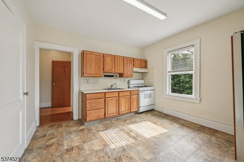 215 Speedwell Avenue, Unit 2 Morristown, NJ 07960 - Photo 3 of 13 a view of a kitchen with a sink and dishwasher with wooden floor