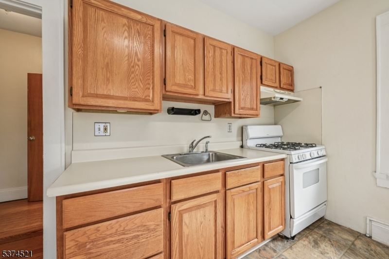 215 Speedwell Avenue, Unit 2 Morristown, NJ 07960 - Photo 4 of 13 a kitchen with stainless steel appliances granite countertop a sink stove and cabinets
