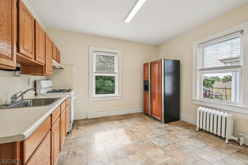 215 Speedwell Avenue, Unit 2 Morristown, NJ 07960 - Photo 5 of 13 a kitchen with stainless steel appliances granite countertop a refrigerator and a sink