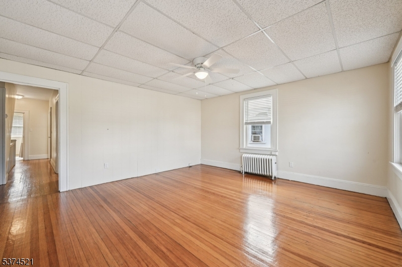215 Speedwell Avenue, Unit 2 Morristown, NJ 07960 - Photo 6 of 13 a view of empty room with wooden floor and fan