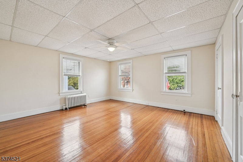 215 Speedwell Avenue, Unit 2 Morristown, NJ 07960 - Photo 7 of 13 an empty room with wooden floor and windows