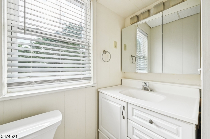 215 Speedwell Avenue, Unit 2 Morristown, NJ 07960 - Photo 10 of 13 a bathroom with a sink a toilet and a mirror