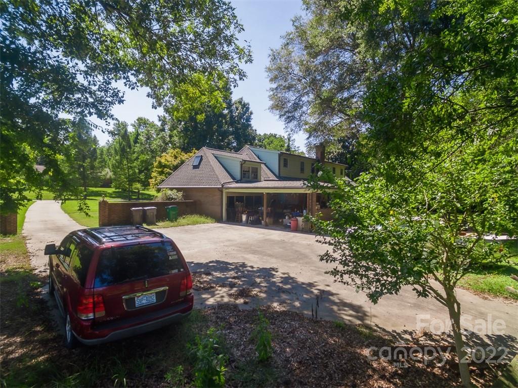7300 Lancer Drive Charlotte, NC 28226 - Photo 12 of 48 a front view of a house with garden