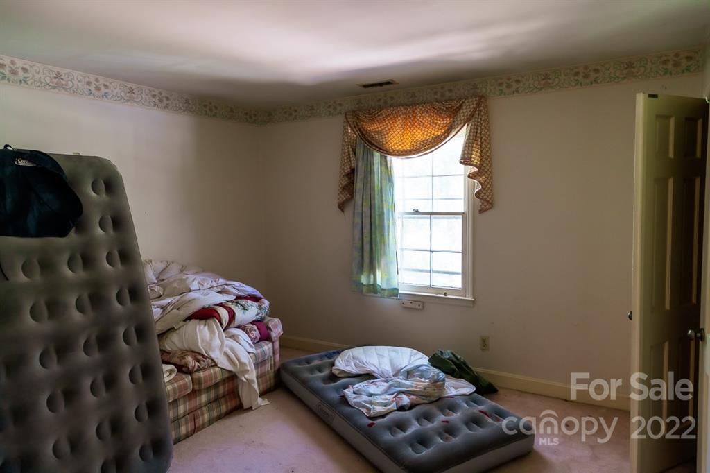 7300 Lancer Drive Charlotte, NC 28226 - Photo 22 of 48 a bedroom with a bed and a window