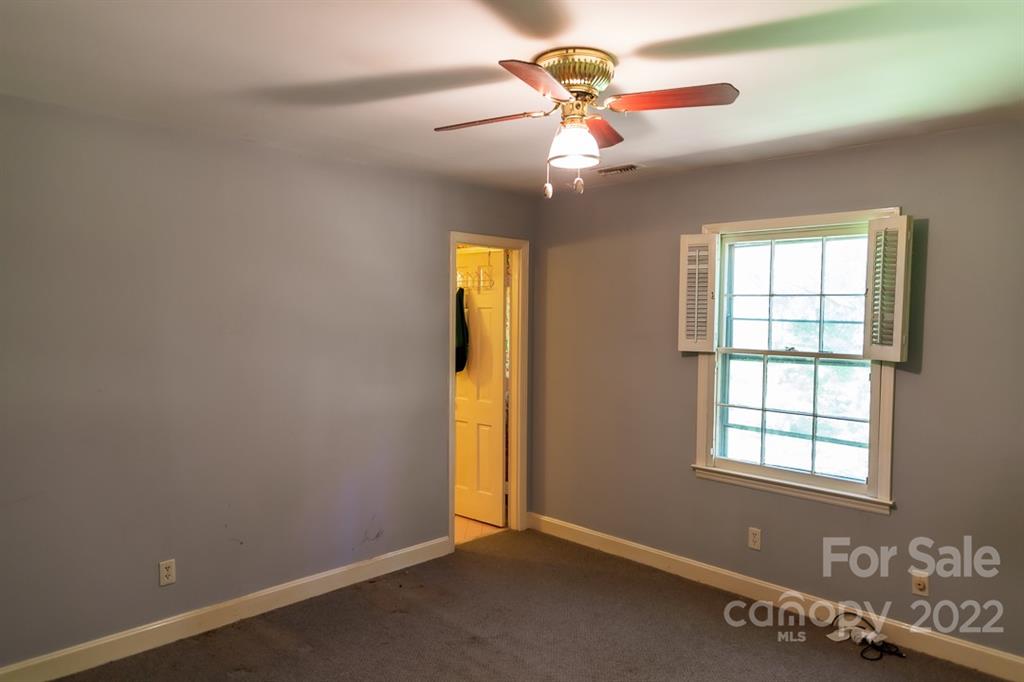 7300 Lancer Drive Charlotte, NC 28226 - Photo 26 of 48 an empty room with windows and fan