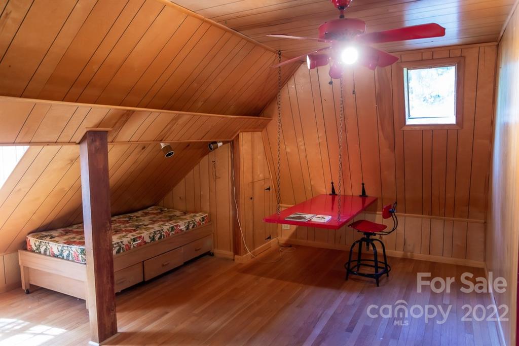 7300 Lancer Drive Charlotte, NC 28226 - Photo 30 of 48 a bedroom with a bed and a chair