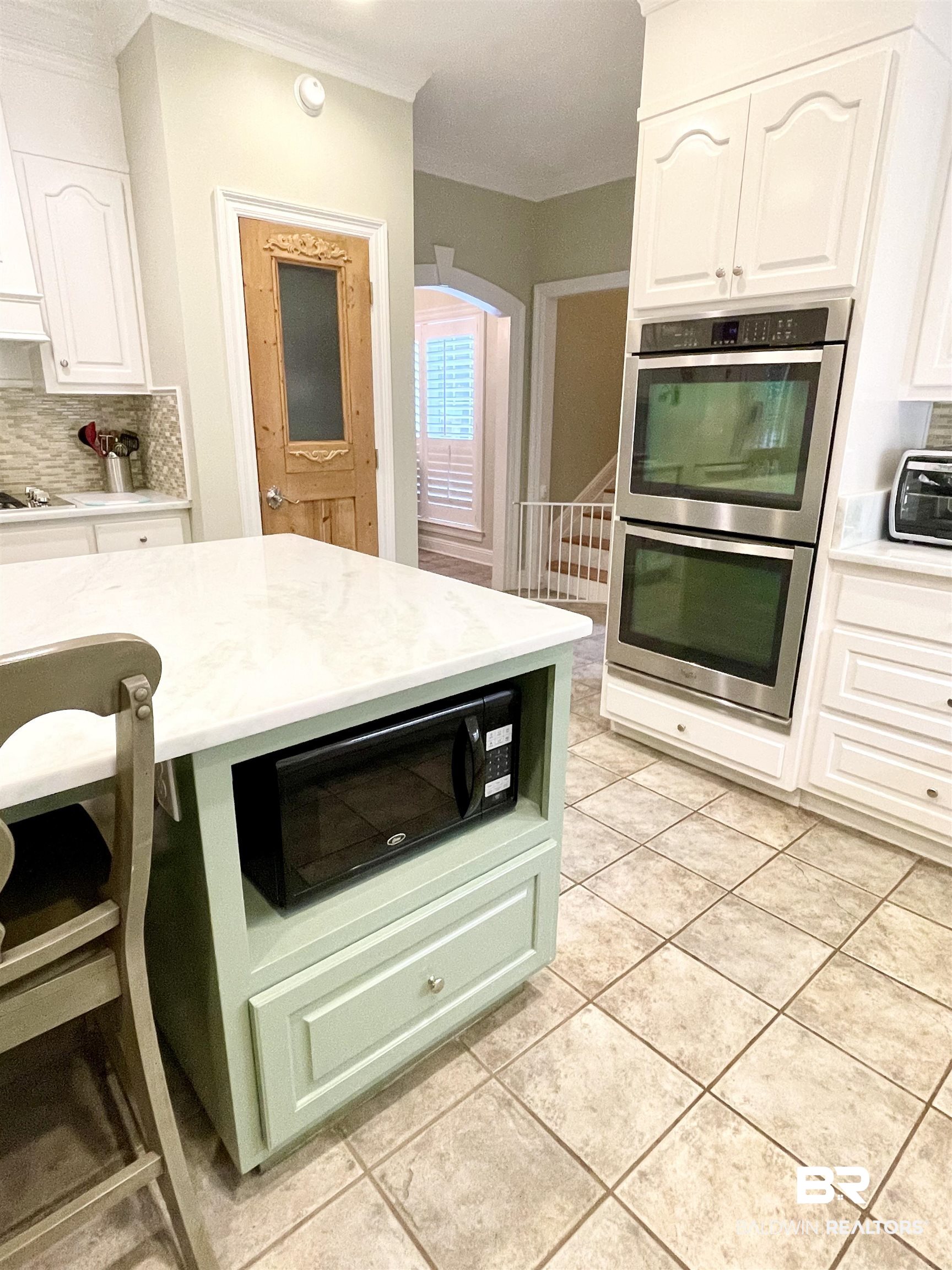 202 Potters Mills Road Daphne, AL 36526 - Photo 12 of 29 Kitchen featuring decorative backsplash, white cabinetry, stainless steel double oven