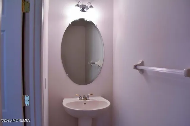 a bathroom with a sink and mirror