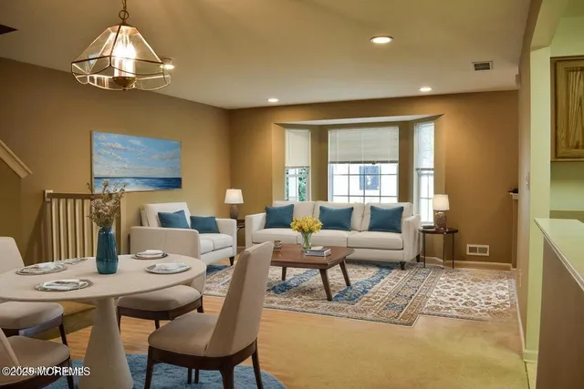 a living room with furniture and a chandelier