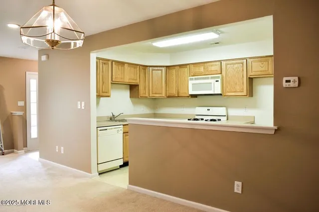 a kitchen with stainless steel appliances a sink and cabinets