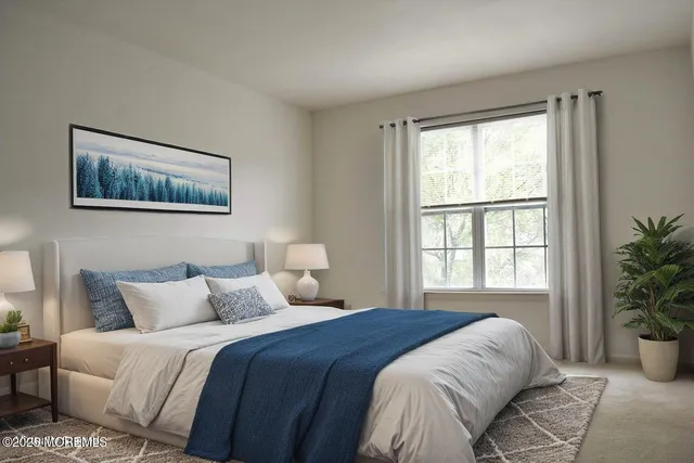 a bedroom with a large bed and a potted plant