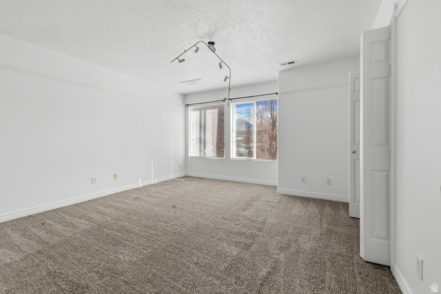 977 East 100 South Payson, UT 84651 - Photo 12 of 19 Unfurnished bedroom featuring carpet flooring and a textured ceiling