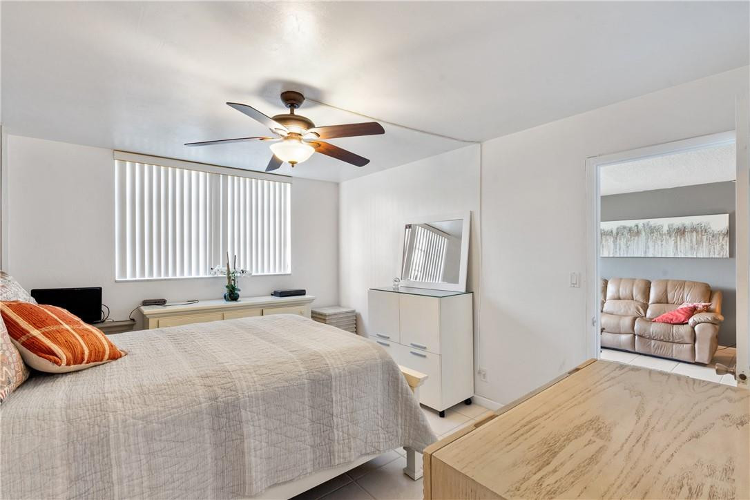 4500 North Federal Highway, Unit 150F Lighthouse Point, FL 33064 - Photo 13 of 18 a bedroom with a bed and a chandelier