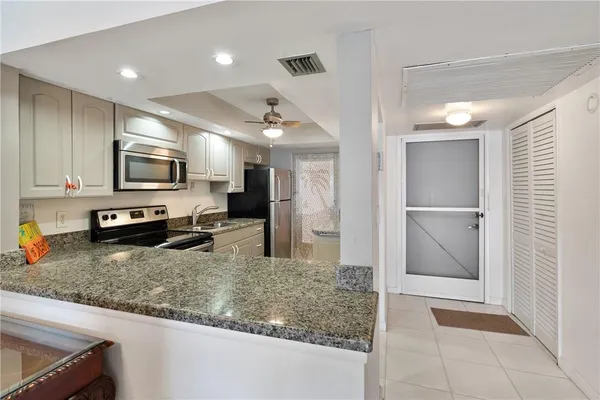 a kitchen with a refrigerator and a sink