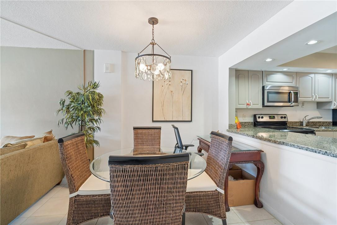 4500 North Federal Highway, Unit 150F Lighthouse Point, FL 33064 - Photo 7 of 18 a living room with stainless steel appliances kitchen island granite countertop furniture and a potted plant