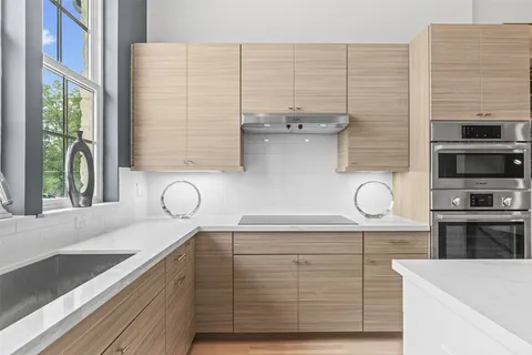 a view of cabinets a oven and a counter space