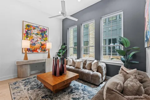 a living room with furniture potted plant and a window