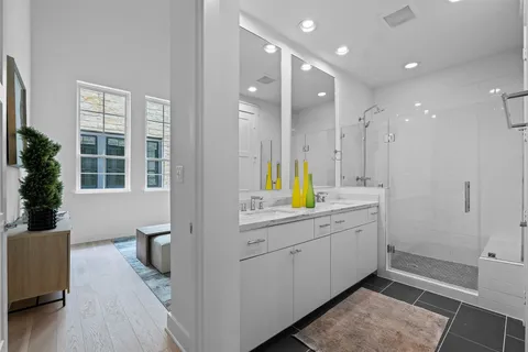 a view of a kitchen with a sink and dishwasher with wooden floor