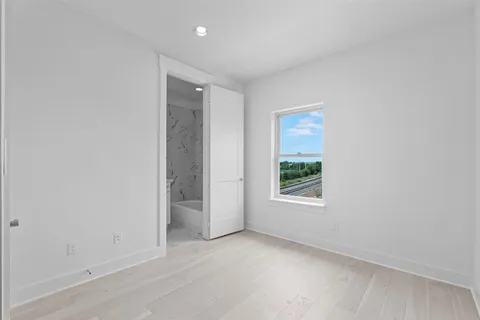 an empty room with windows and closet