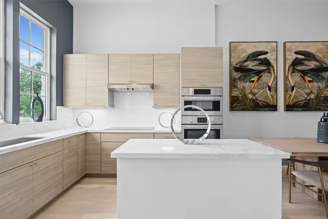 a kitchen with stainless steel appliances a sink a stove and a microwave