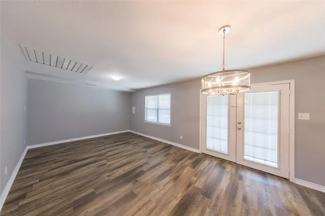 a kitchen with kitchen island a sink wooden floor and counter top space