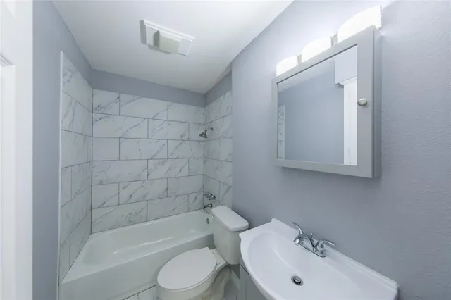 a bathroom with a sink toilet and bathtub