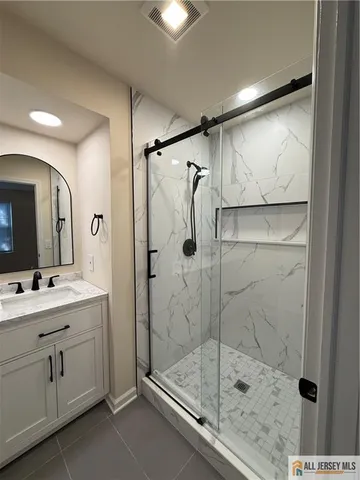 a bathroom with a shower sink and mirror