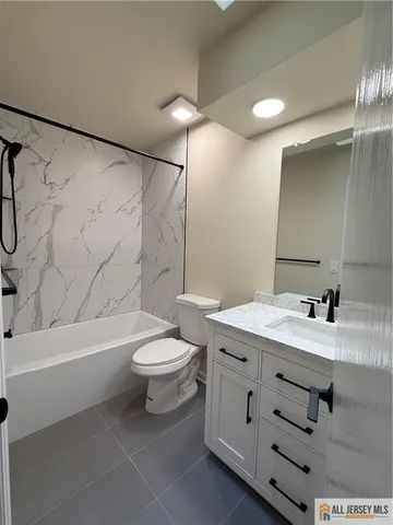 a bathroom with a sink a toilet and a bathtub