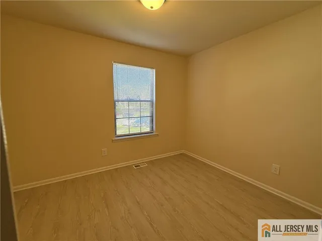 an empty room with a empty space and a window