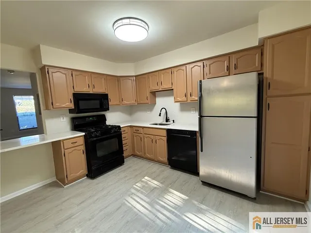 a kitchen with a refrigerator stove and microwave