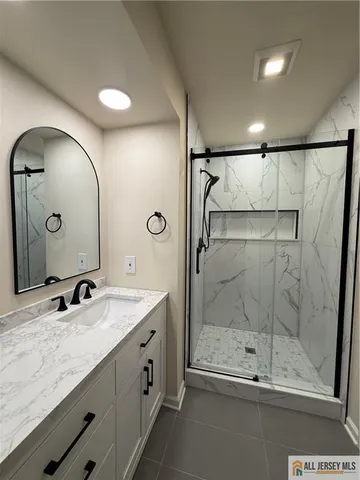 a bathroom with a shower sink and mirror