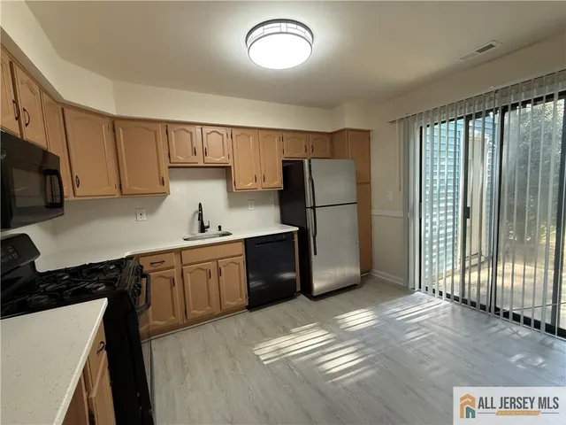 a kitchen with a refrigerator and a sink