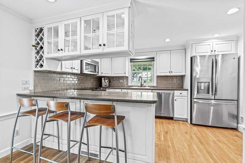 21 Madison Road Wellesley, MA 02481 - Photo 12 of 26 a kitchen with stainless steel appliances granite countertop a kitchen island a stove a cabinets and a refrigerator
