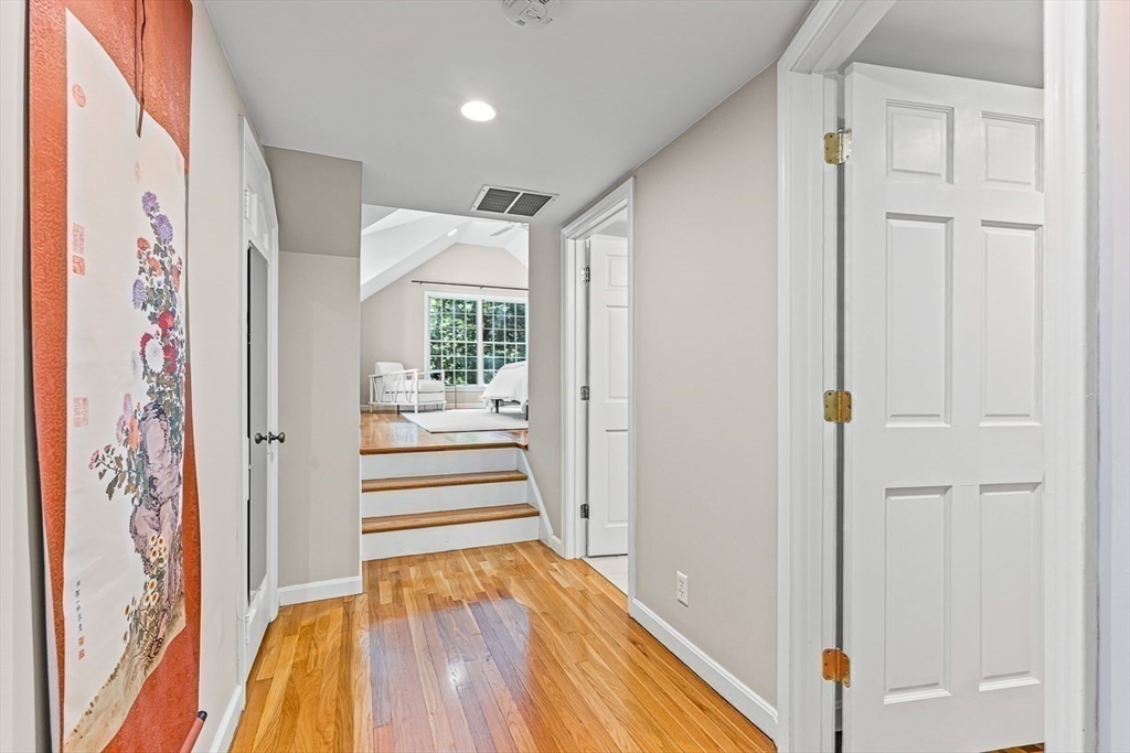21 Madison Road Wellesley, MA 02481 - Photo 14 of 26 a view of a hallway with wooden floor and staircase
