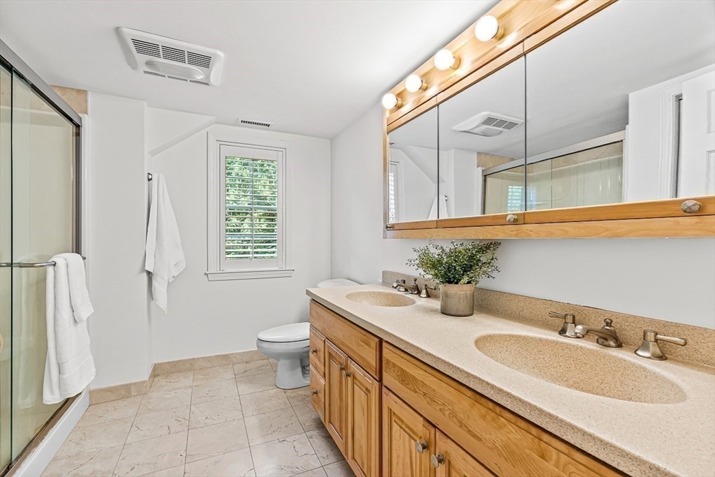 21 Madison Road Wellesley, MA 02481 - Photo 17 of 26 a bathroom with a granite countertop sink and a mirror