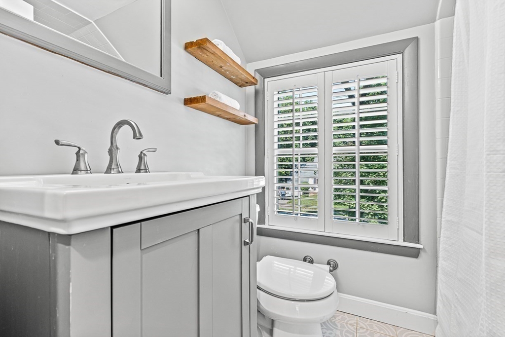 21 Madison Road Wellesley, MA 02481 - Photo 21 of 26 a bathroom with a granite countertop sink and a toilet