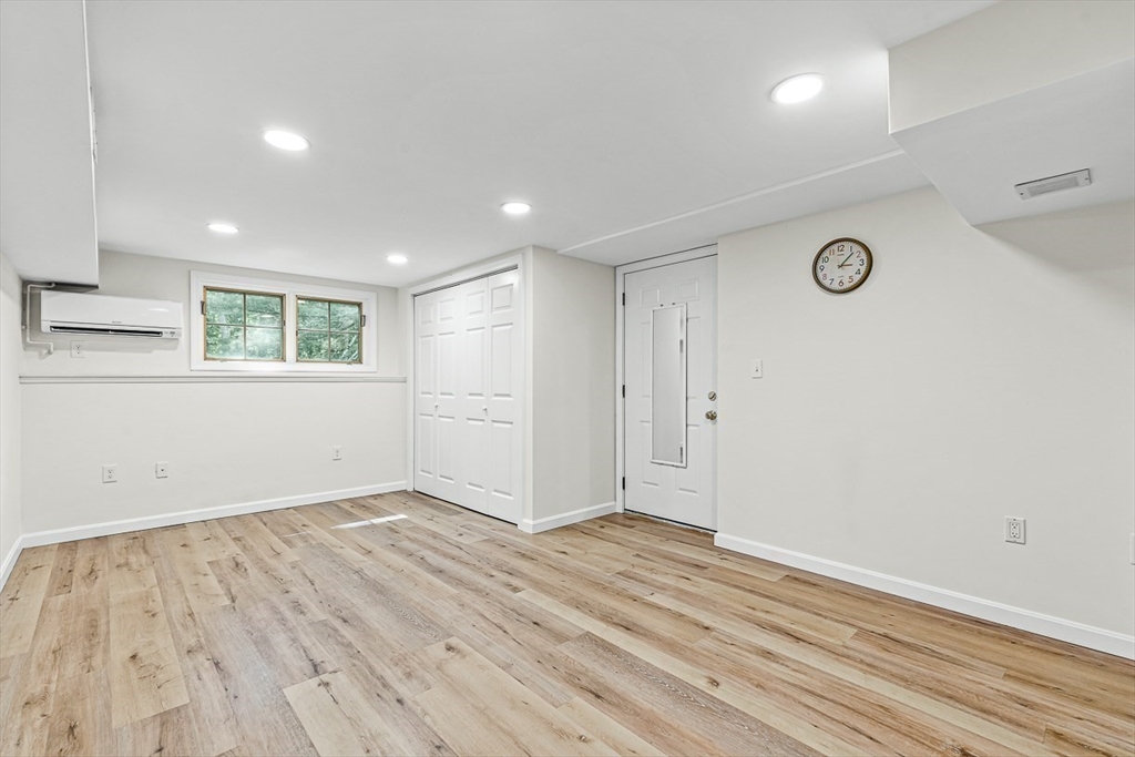 21 Madison Road Wellesley, MA 02481 - Photo 22 of 26 an empty room with wooden floor and windows