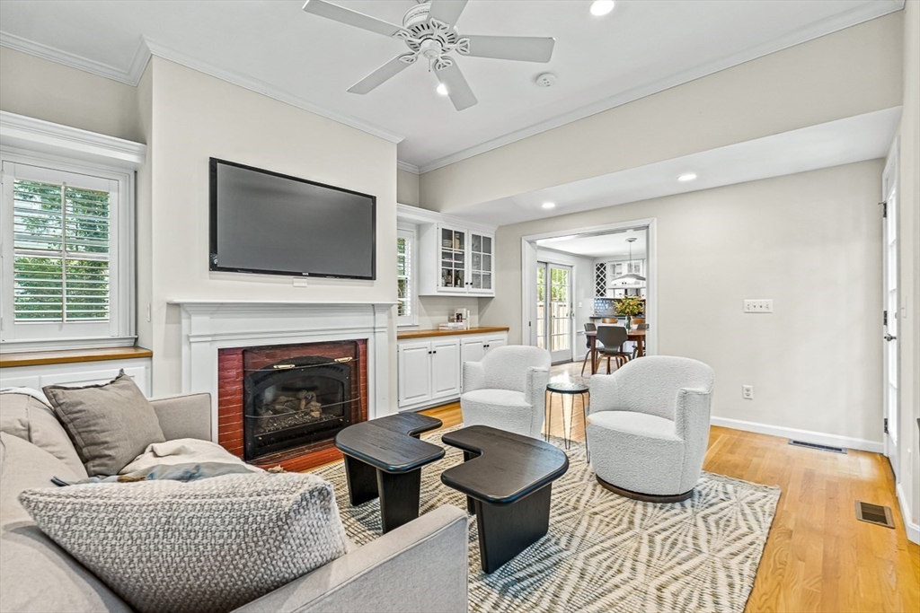 21 Madison Road Wellesley, MA 02481 - Photo 6 of 26 a living room with furniture a flat screen tv and a fireplace