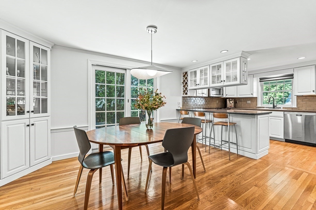 21 Madison Road Wellesley, MA 02481 - Photo 10 of 26 a kitchen with stainless steel appliances granite countertop a stove a kitchen island a table and chairs